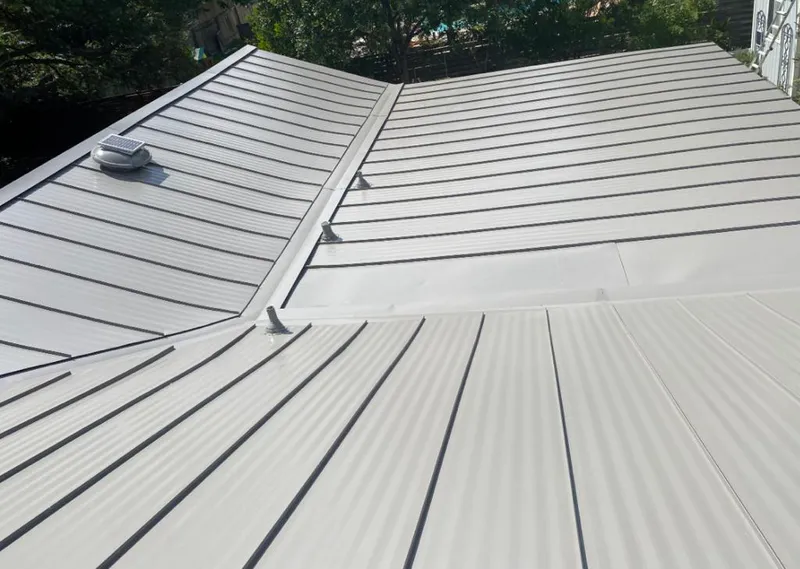 Solar attic fan installed on a metal roof for Roof Ventilation in Posen